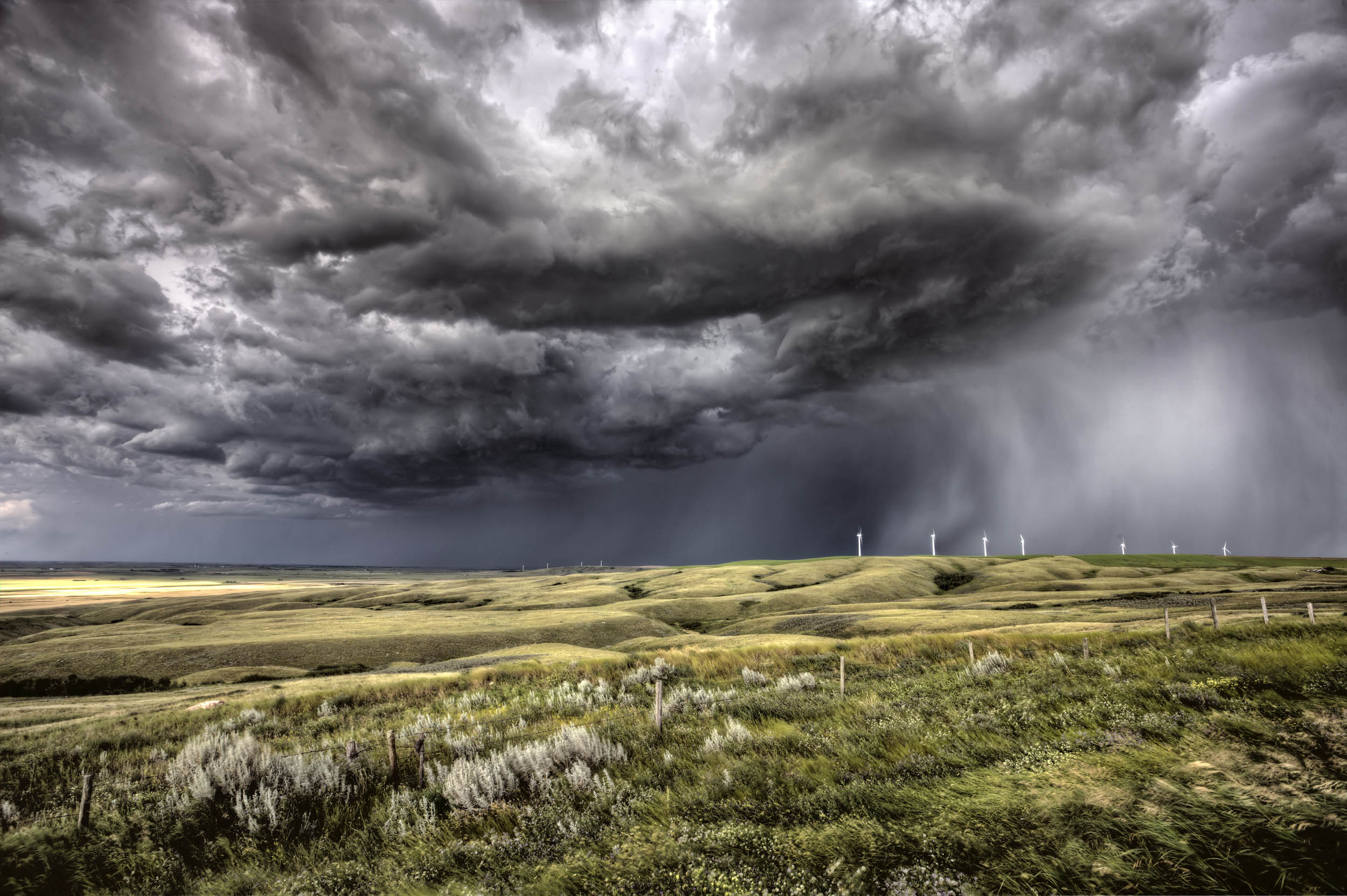 Storm clouds forming over a wind farm - Earth.com